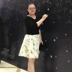 Shuang Zhang writing on a blackboard